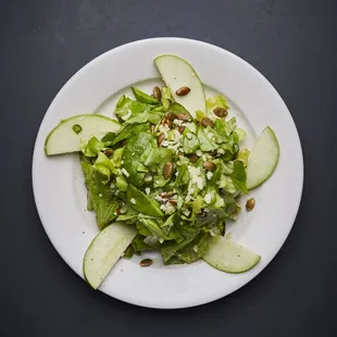 a white plate with a salad on it