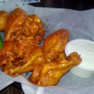 8 chicken wings with hot sauce. Large wings with a traditional red hot sauce. Very good!