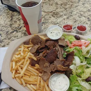 Gyros Plate w/2 Tsaziki sauces, French fries, small Greek Salad and a grilled pita.