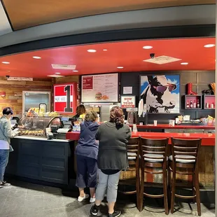 a group of people standing at a counter