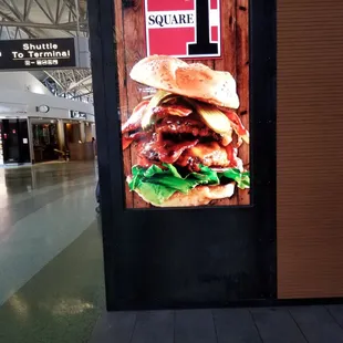 a burger on a bun with lettuce and tomato