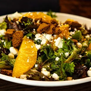 FLORIDA ORANGE &amp; GOAT CHEESE SALAD Mixed local greens, orange segments, goat cheese, ginger cookie crumble, blueberry mango vinaigrette