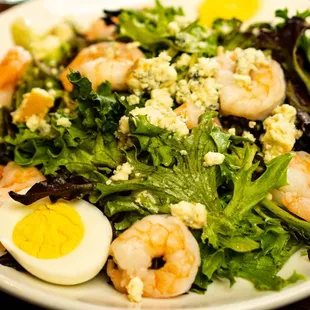 SHRIMP BAY
 Gulf shrimp, smoked Moody Bleu cheese, hard-boiled egg, mixed local greens, Greek vinaigrette