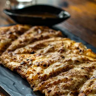 FRENCH ONION SOUP FLATBREAD Caramelized sweet onions, provolone cheese, Au Jus