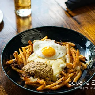 RUST BELT FRITES Short rib, fried egg, brown gravy, white cheddar curd, whole grain mustard