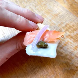 a person holding a piece of food