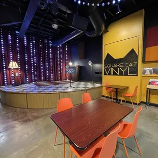 a table and orange chairs