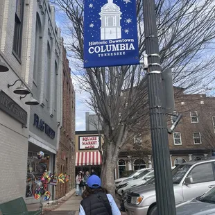 a woman walking down a sidewalk