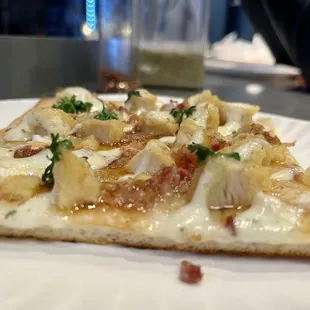 a slice of pizza on a paper plate