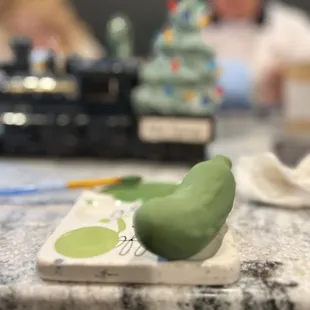 Black Friday ceramic painting with the family. This is the foundation of a Christmas Pickle.