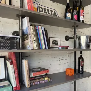 shelves with wine, books, and wine glasses