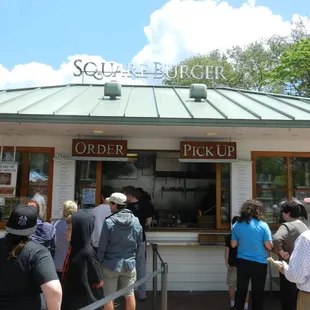 a group of people standing in line outside a store