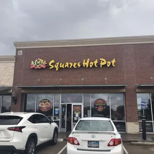 two cars parked in front of the store