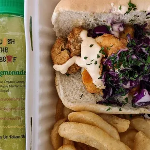 Seafood po&apos; boy has vegan shrimp, vegan crab cakes, slaw and vegan remoulade on it. With fries and excellent kale lemonade.