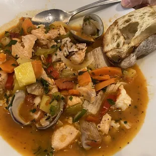 Bouillabaisse.  Fish, shrimp, clams, potatoes, carrots, bell peppers, in a tomato-lobster broth.  Served with crusty bread.