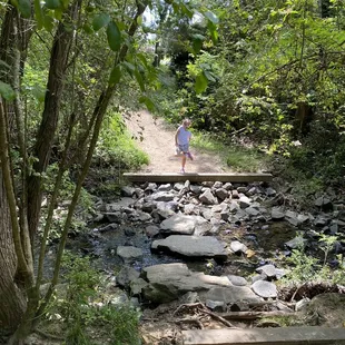 My daughter having fun crossing the water