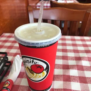 a paper cup with a straw and a fork
