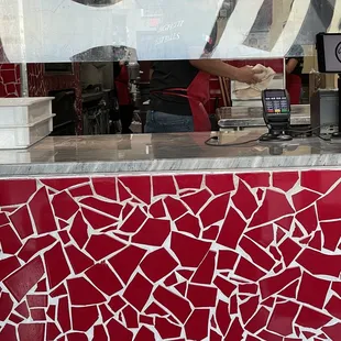 a red and white mosaic wall