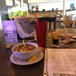 a bowl of soup and a bag of chips
