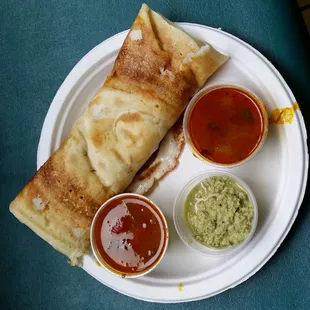 Hot dosa with sambar, chicken gravy and coconut chutney.