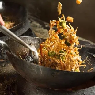 a wok of food being cooked