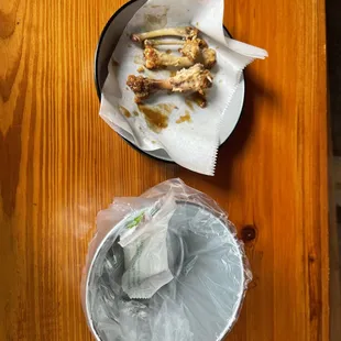 a bowl of food and a pan of food on a wooden table