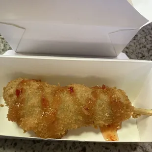 a chicken skewer in a box