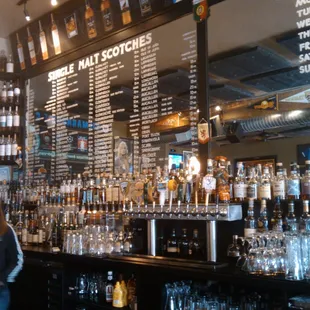 a woman standing in front of the bar