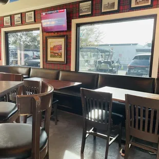 tables and chairs in front of a window