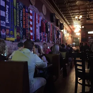 people sitting at tables in a pub