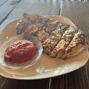 Cheesy bread with a side of marinara sauce