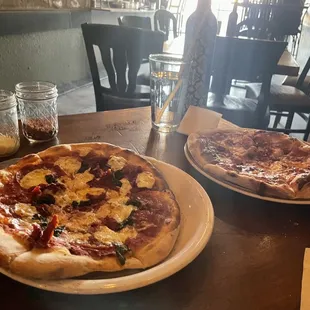 two pizzas on a table
