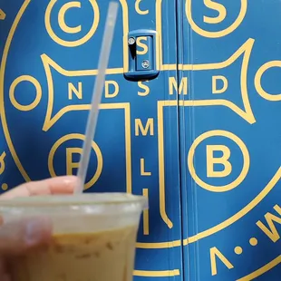 a hand holding a cup of coffee