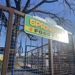 a sign in front of a playground