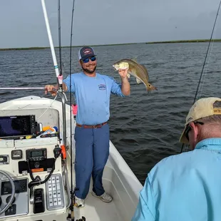 Capt Ed holds up a nice redfish