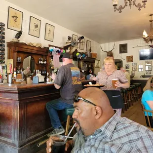 a group of people sitting at a bar