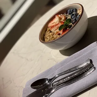 a bowl of oatmeal and a spoon on a table