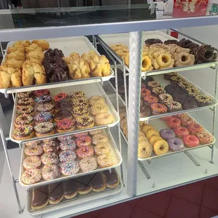 a variety of donuts in a display case