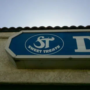 a blue and white street sign