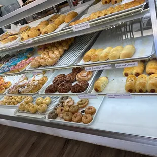 a variety of doughnuts in a display case