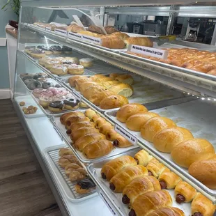 a display case with a variety of pastries