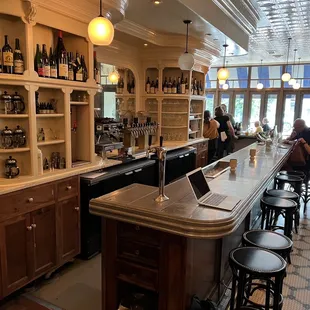 people sitting at a bar in a restaurant