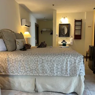 a hotel room with a bed and dresser