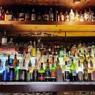 a shelf of liquor bottles
