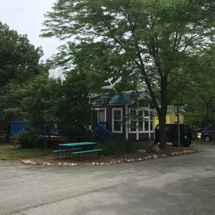a purple house with a blue roof