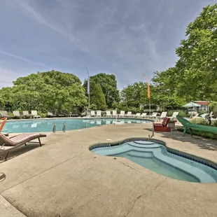 an outdoor pool with lounge chairs