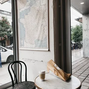 a table and two chairs in front of a window