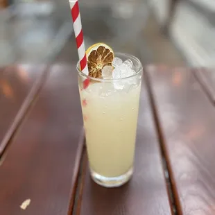 a glass of lemonade on a wooden table