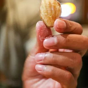 a hand holding a donut