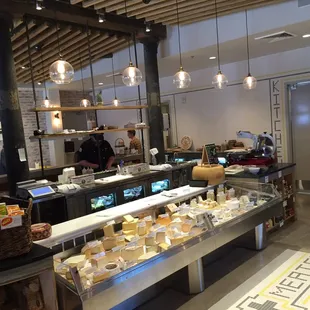 Cool lighting fixtures over the cheese, such a light and airy space